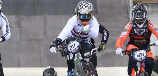 Adults participating in BMX on a track