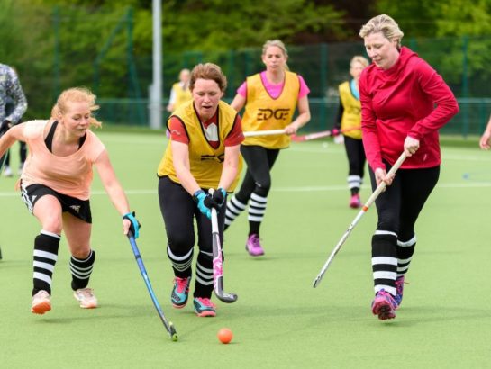 Group of women playing Hockey