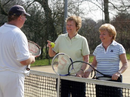 Seniors playing a game of tennis