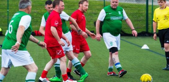 Men playing walking football on 3G pitch