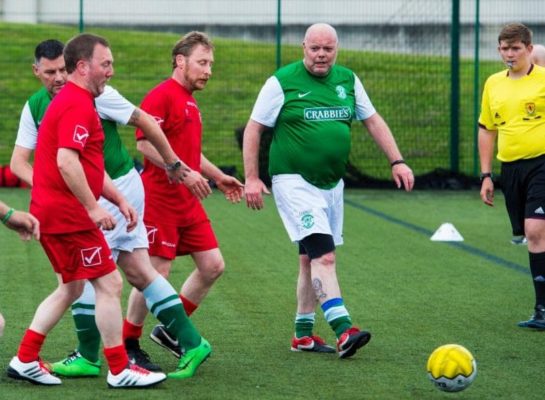 Men playing walking football on 3G pitch