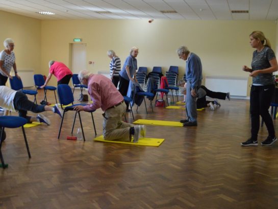 Kneeling leg stretch at Falls class