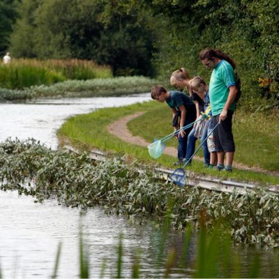 Family with fishing net in river