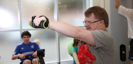 Man using hand Weights in an inclusive class