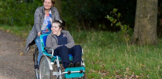 Wheelchair user with carer on a wheelchair bike