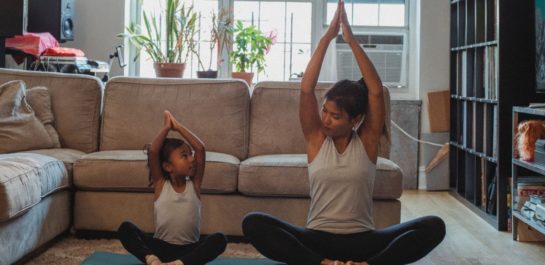 Parent and child doing yoga at home