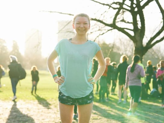 Woman stood smiling in running clothes