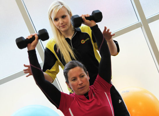 Wheelchair user lifting dumbells