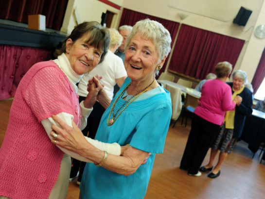 Two senior women dancing