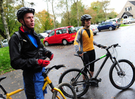 Two men stood with bikes