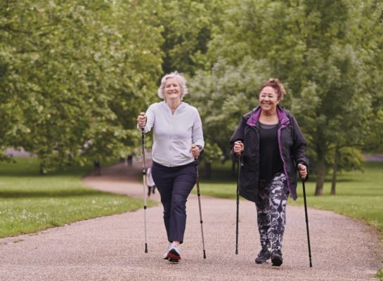Two senior women nordic walking in the park
