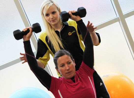 Wheelchair user lifting dumbells