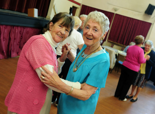 Two senior women dancing