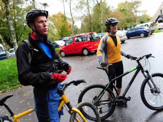 Two men stood with bikes