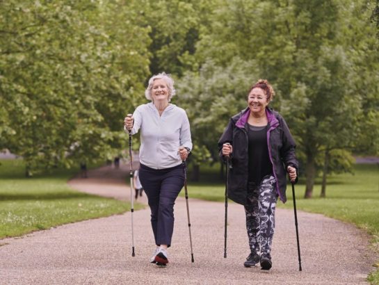 Two senior women nordic walking in the park