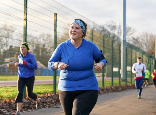 Woman running in a running group