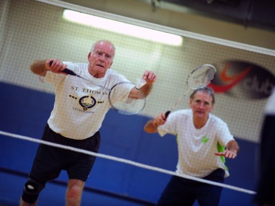 Senior men playing doubles Badminton