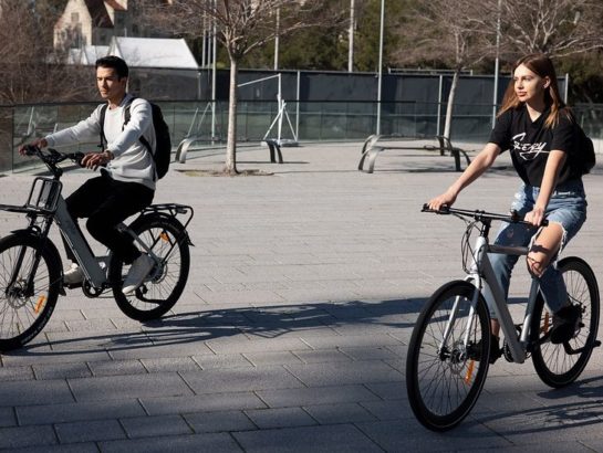 two adults riding E-bikes