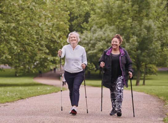 Two senior women nordic walking in the park