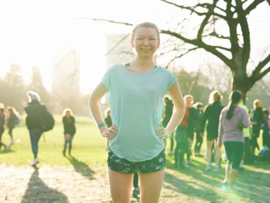 Woman stood smiling in running clothes