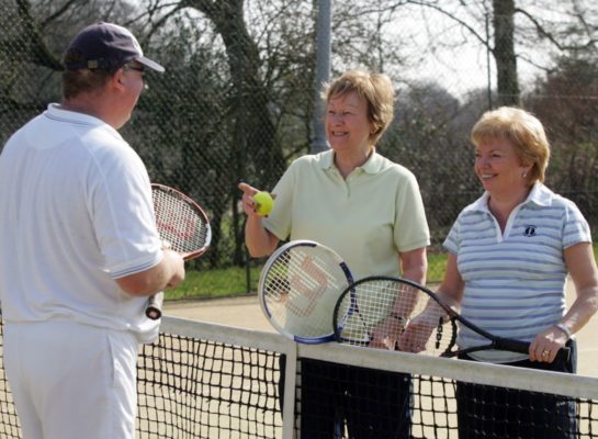 Seniors playing a game of tennis