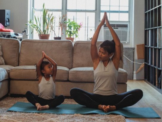 Parent and child doing yoga at home