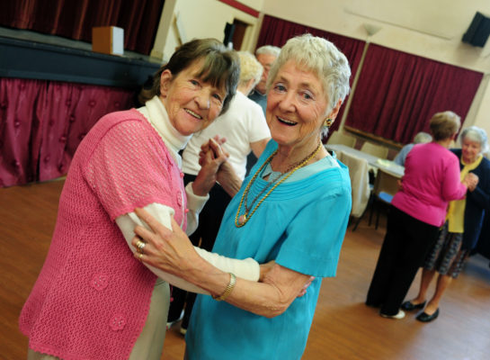Two senior women dancing