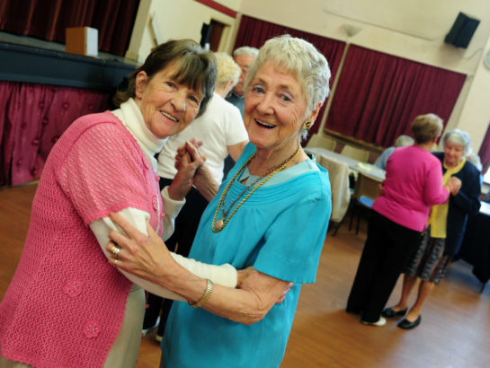 Two senior women dancing