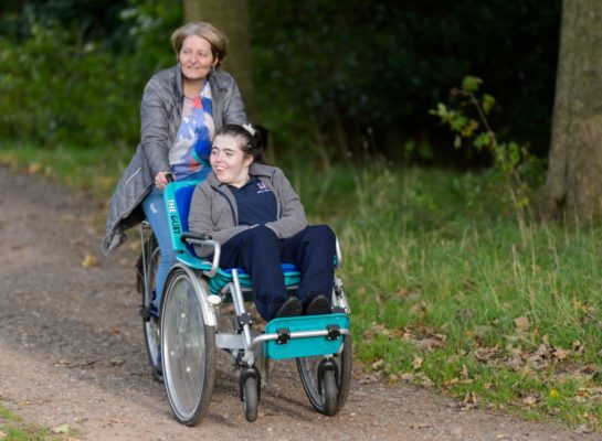 Wheelchair user with carer on a wheelchair bike