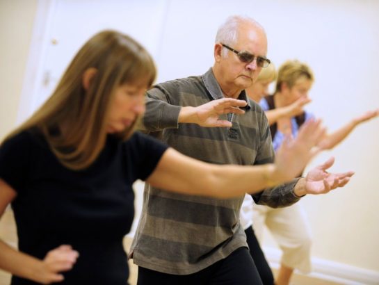 Group of seniors participating in a Tai Chi class