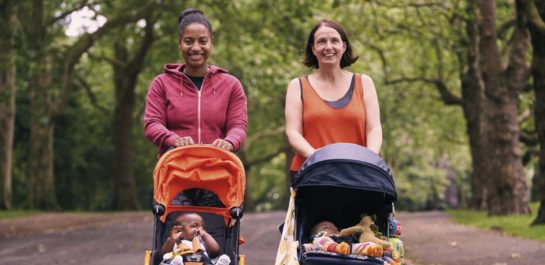 Two Women walking with pushchairs