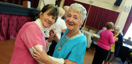Two senior women dancing