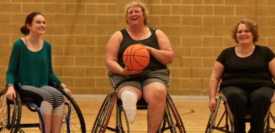 three women playing Wheel chair basketball