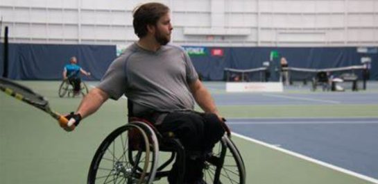 Man playing wheelchair tennis