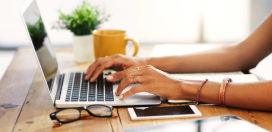 Woman typing on a laptop