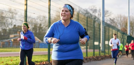 Woman running in a running group