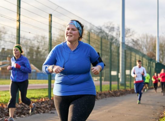 Woman running in a running group