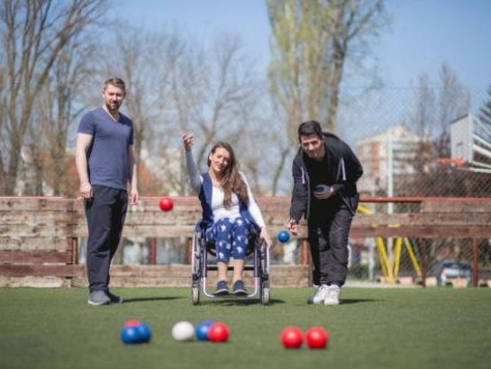 Woman in wheelchair playing Bocchia