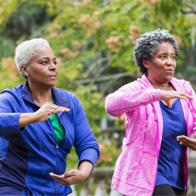 Two women following tai chi movements