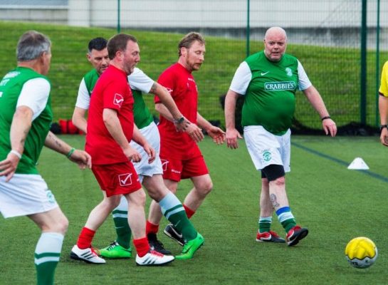 Men playing walking football on 3G pitch