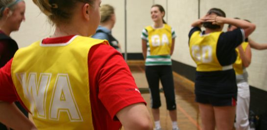 Women stood in Netball bibs